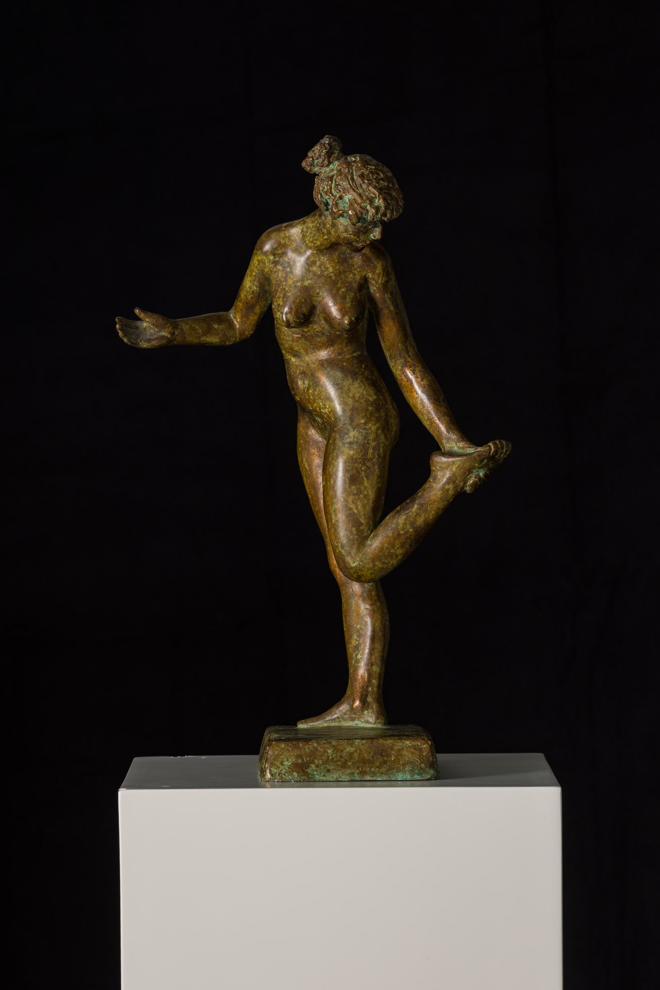 Bronze von Rolf Brem: junge Frau, die auf einem Bein steht und nach ihrem Fuss greift